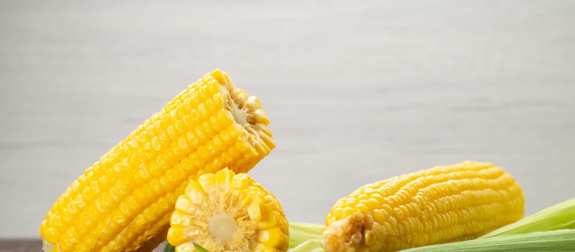 front-view-fresh-yellow-corns-with-peels-grey-food-meal-color