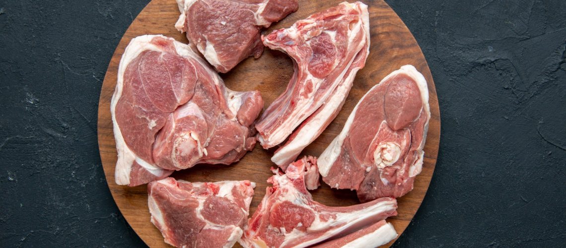 top-view-fresh-meat-slices-raw-meat-round-wooden-desk-dark-food-freshness-animal-cow-meal-food-kitchen